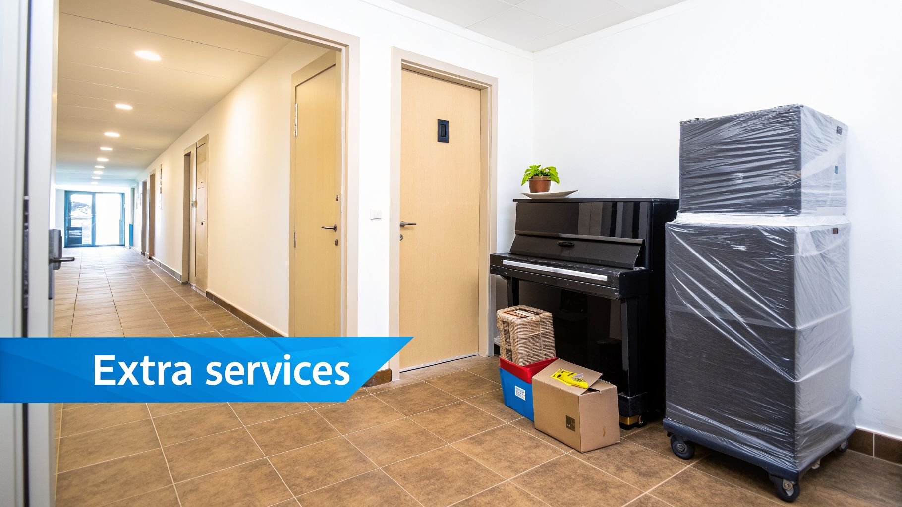 A building hallway featuring a black piano, stacked moving boxes wrapped in plastic, and other items, hinting at relocation services.
